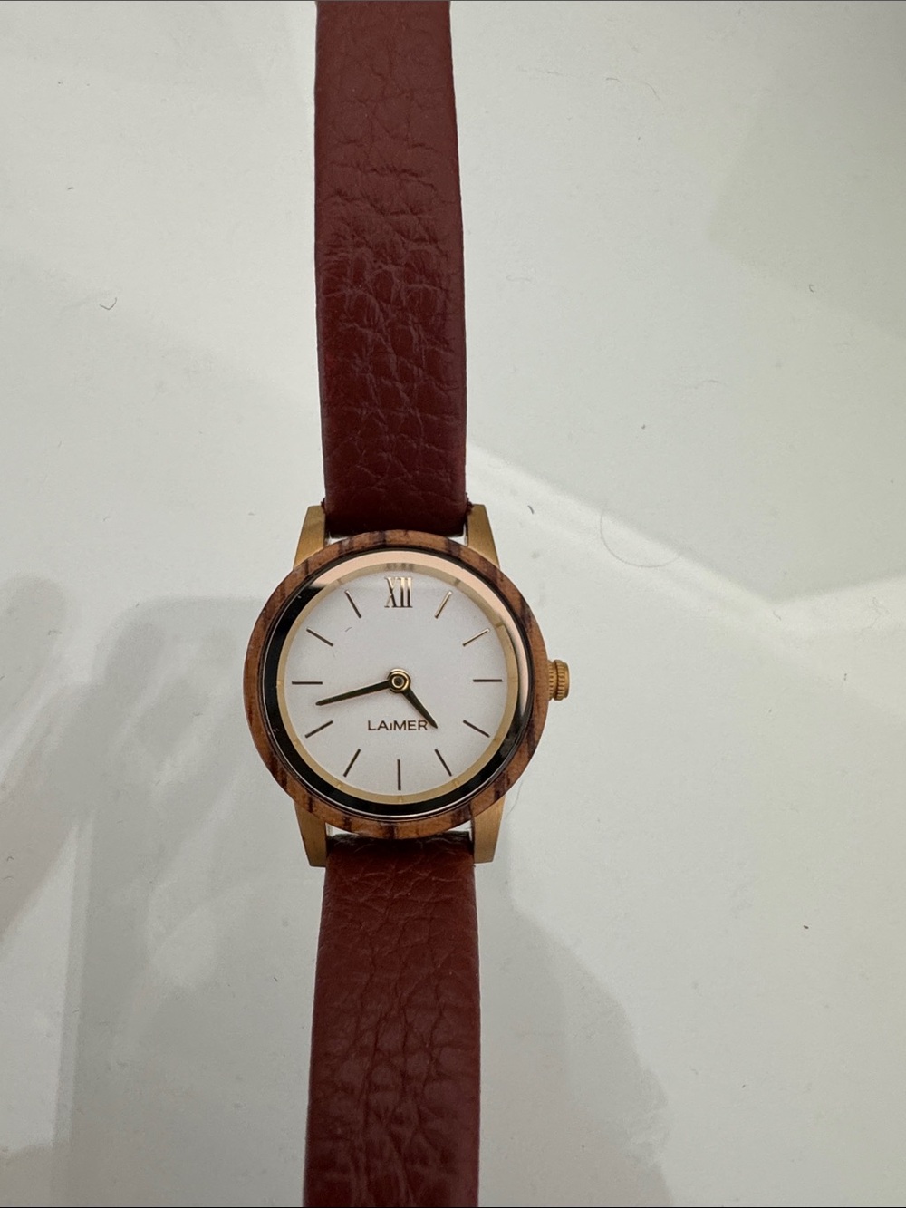 Laimer brown wood watch.